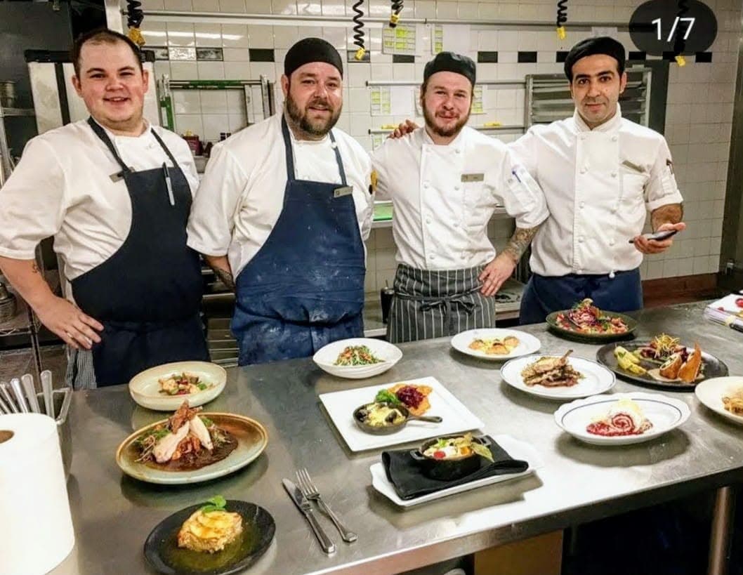 The chef plating with the team